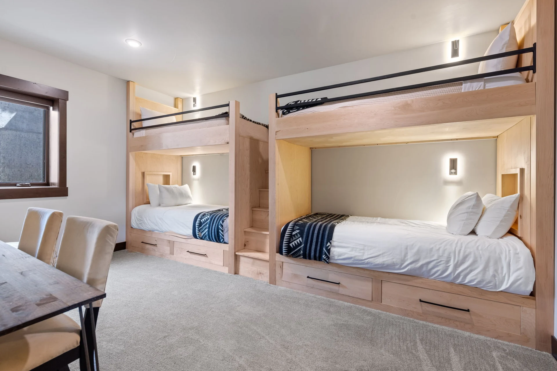 Vendette Peak, bedroom: Custom bunk room with two built-in bunk units, ladders, reading lights, and a small table, luxury vacation rental in Silverthorne, Colorado