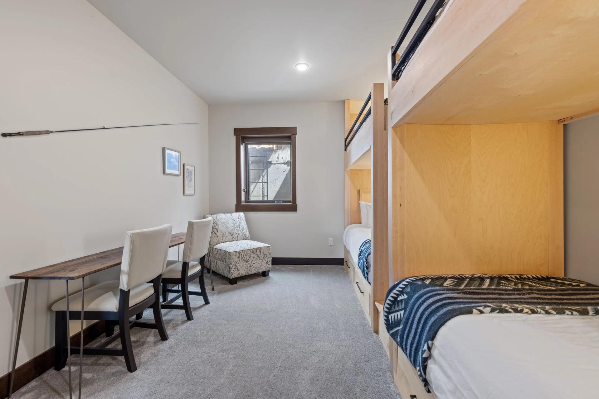 Vendette Peak, bedroom: Side view of the built-in bunks, with a desk, two chairs, an armchair, and a window, luxury vacation rental in Silverthorne, Colorado