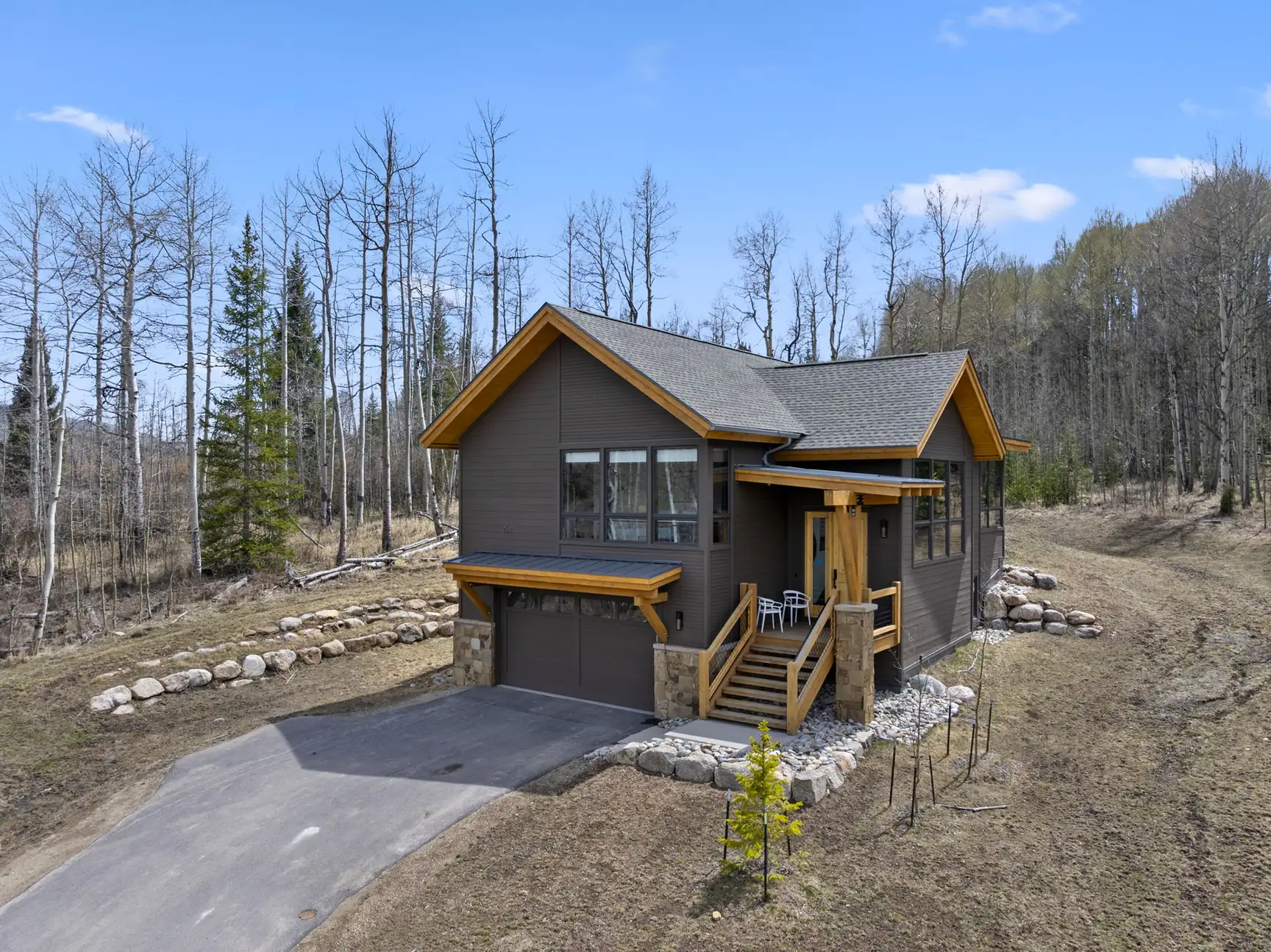 Vendette Peak, exterior: Driveway view of the front gable, heated garage, wood-railed steps, and entry landing, luxury vacation rental in Silverthorne, Colorado